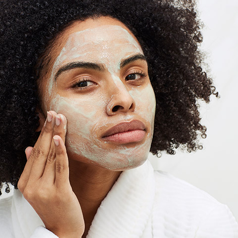 Woman applying Aveeno face mask
